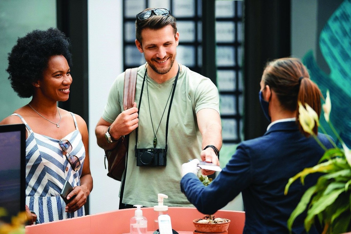Smiling guests checking into a boutique hotel
