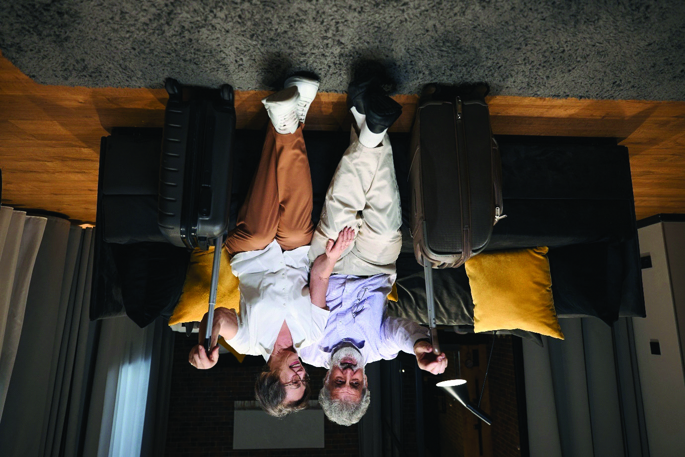 Senior travelers arriving at a hotel suite
